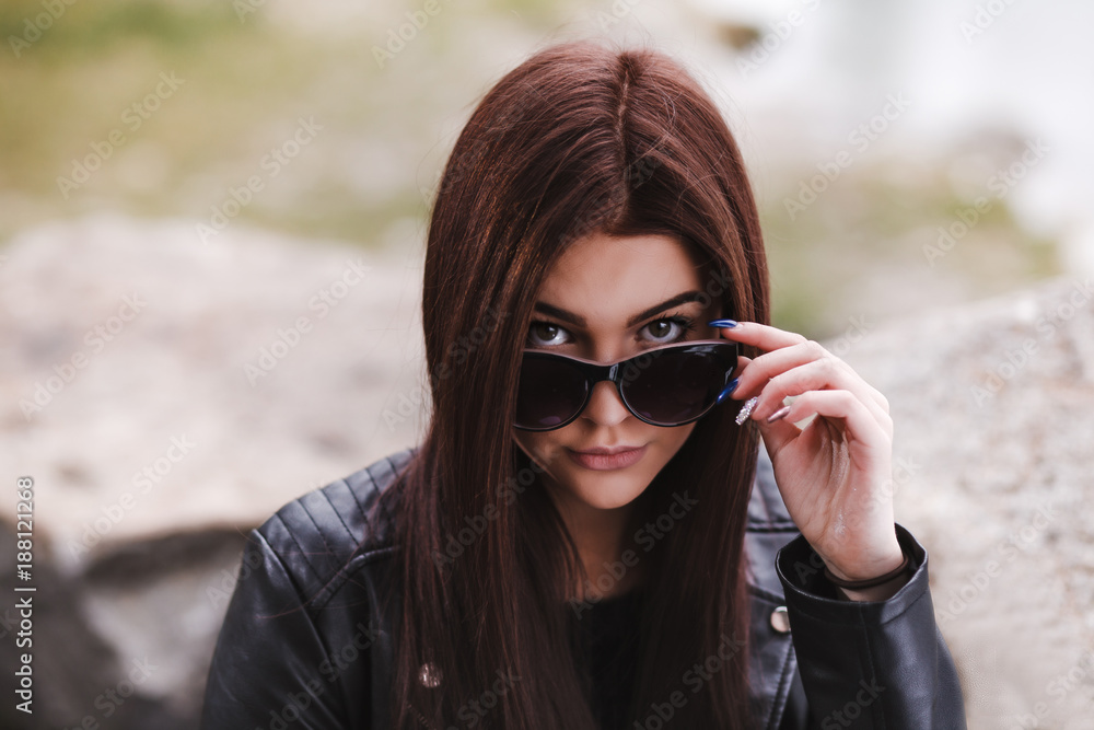 Sexy young woman looking over her sunglasses Sexy young woman looking over her sunglasses