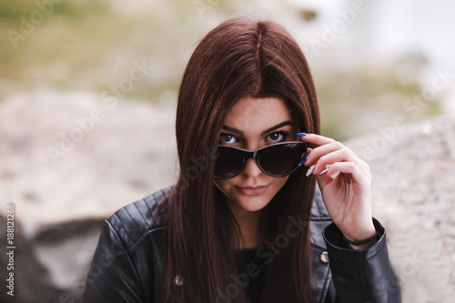 Sexy young woman looking over her sunglasses © Katalin