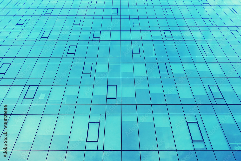 Facade of a modern office corporate building. Modern industrial building with glass. Abstract background. Facade of a modern office corporate building. Modern industrial building with glass. Abstract background.