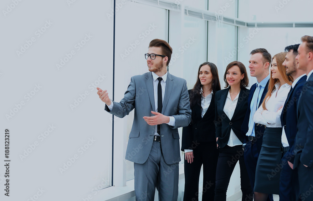 Cheerful businessman discussing a new business project with the members of his team. Cheerful businessman discussing a new business project with the members of his team.