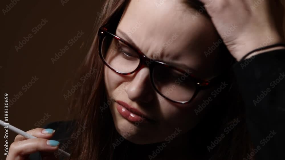 Nervous teen girl with a cigarette Nervous teen girl with a cigarette
