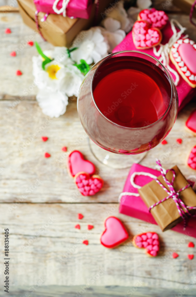 Glass of red wine with heart shape cookies, flowers and gifts Glass of red wine with heart shape cookies, flowers and gifts