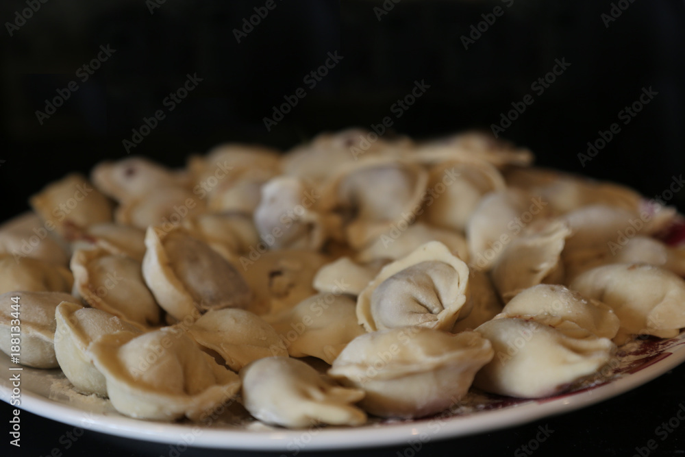 dumpling closeup on a plate on a black background dumpling closeup on a plate on a black background
