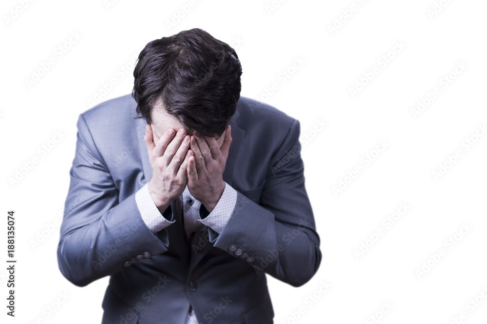 Desperate businessman in grey suit holding his head in sad expression. Desperate businessman in grey suit holding his head in sad expression.