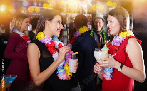 Two women on Hawaiian party at nightclub