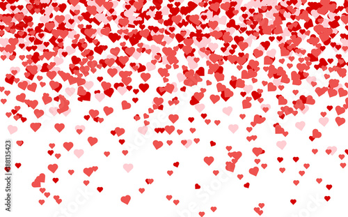 Heart confetti of Valentines petals falling on white background.