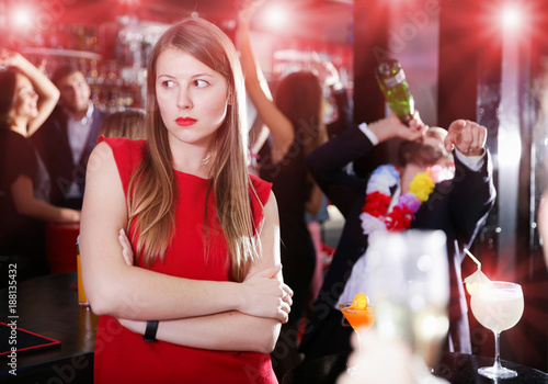 Girl upset with drunk boyfriend on Hawaiian party in bar