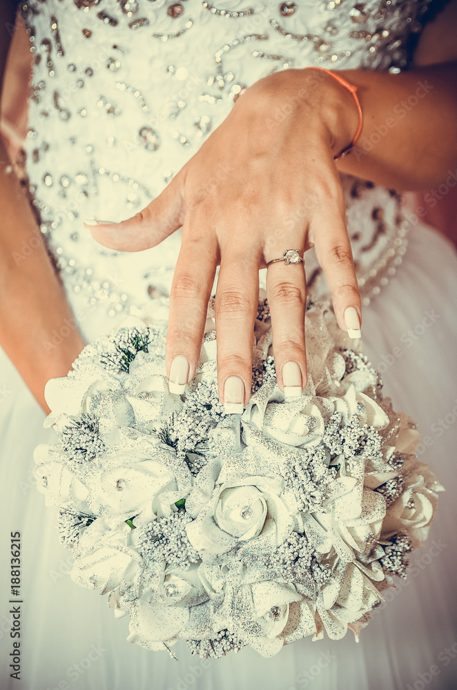 close up of bride holding bouquet of white roses close up of bride holding bouquet of white roses