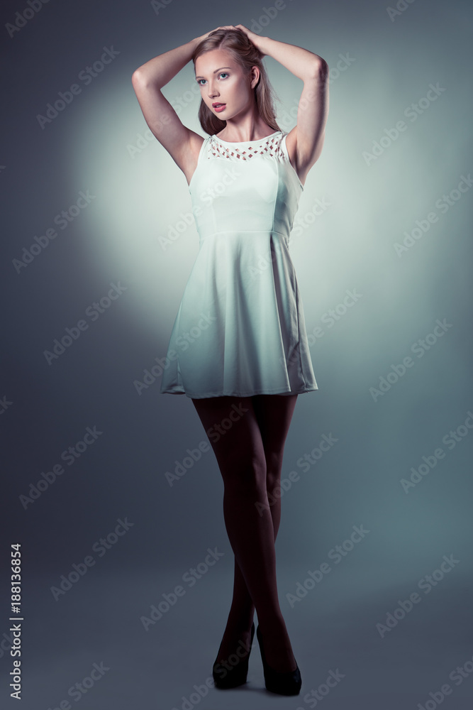 Moody studio portrait of a beautiful young brunette woman with long hair