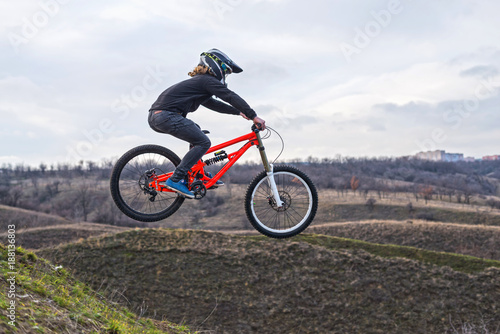 Fototapeta Naklejka Na Ścianę i Meble -  Professional cyclist jumping on a mountain bike, a free space.