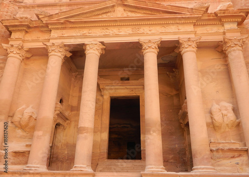 The lower level of Al-Khazneh Treasury temple facade in Petra, Jordan, with the pediment supported by columns, sculptures of the twins Castor and Pollux and the central doorway