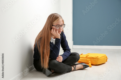 Upset teenage girl sitting ...