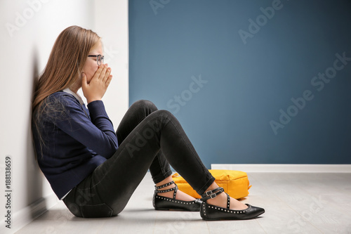 Upset teenage girl sitting ...