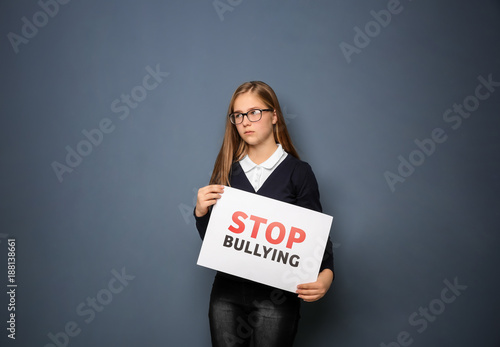 Teenage girl holding sign "...