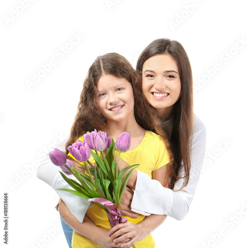Young woman and her daughter with tulip bouquet on white background. Mother's day celebration