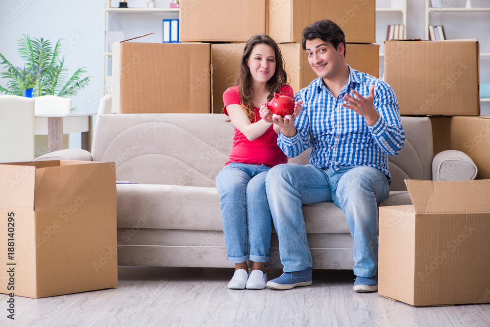 Young pair moving in to new house with boxes Young pair moving in to new house with boxes