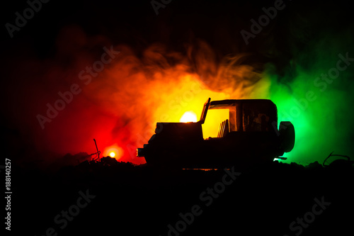 War Concept. Military silhouettes fighting scene on war fog sky background  World War Soldiers Silhouettes Below Cloudy Skyline At night. Attack scene. Army jeep vehicles with soldiers