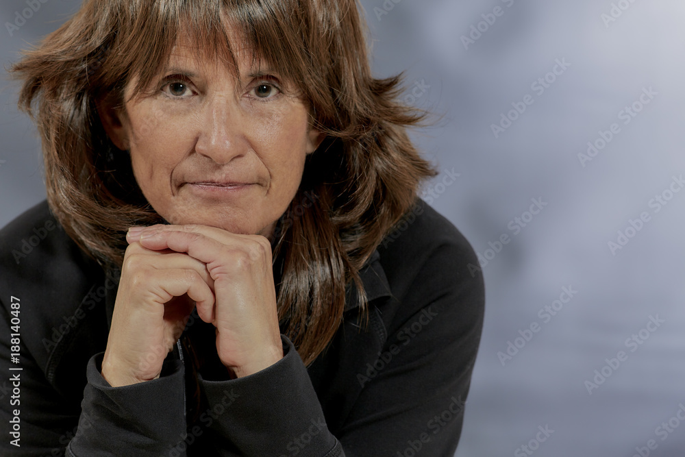 Attractive Woman with Brown Hair resting her Finger on her Cheek Attractive Woman with Brown Hair resting her Finger on her Cheek