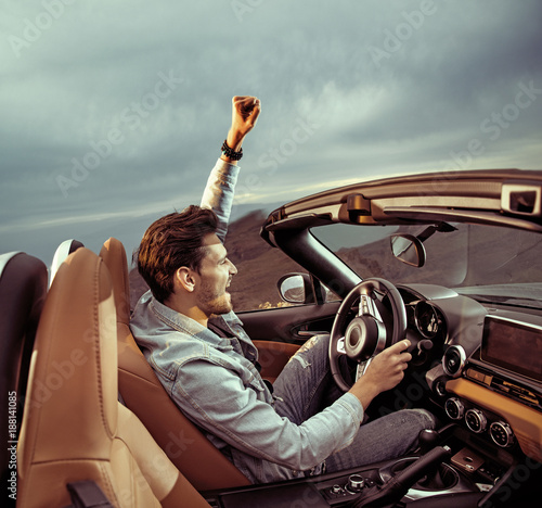 Handsome man riding a luxuriois convertible car © konradbak