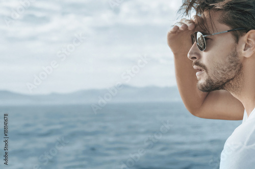 Profile portrait of a handsome man relaxing on the boat © konradbak