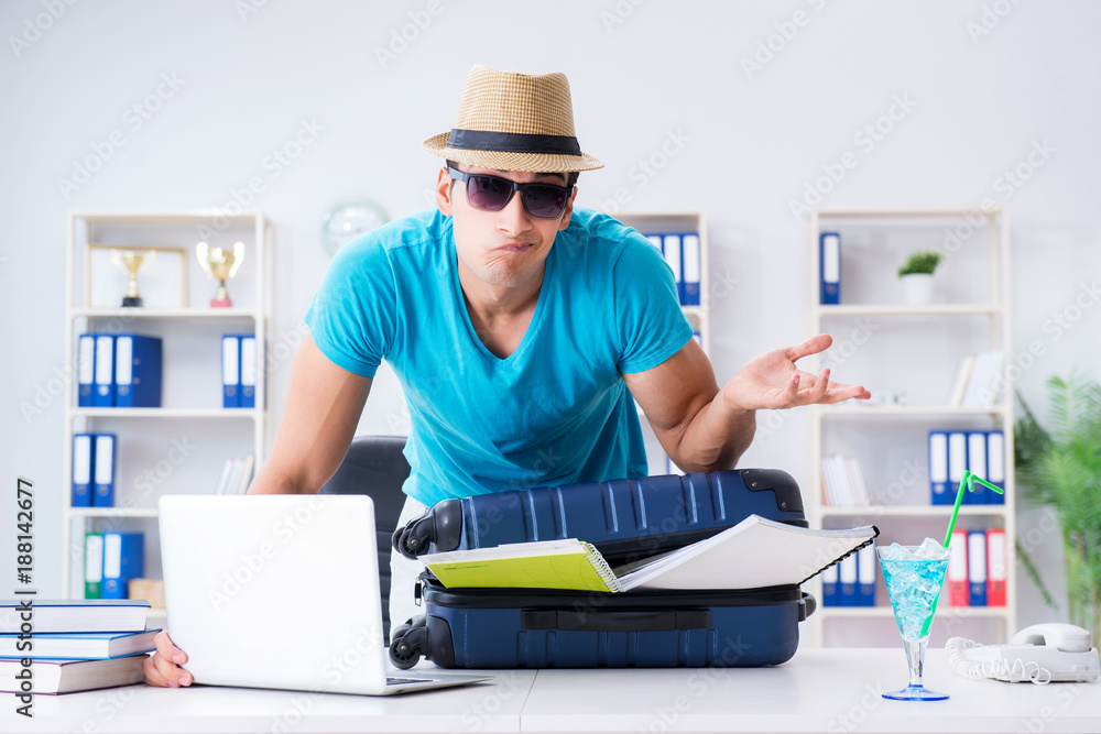 Businessman preparing for vacation in the office Businessman preparing for vacation in the office