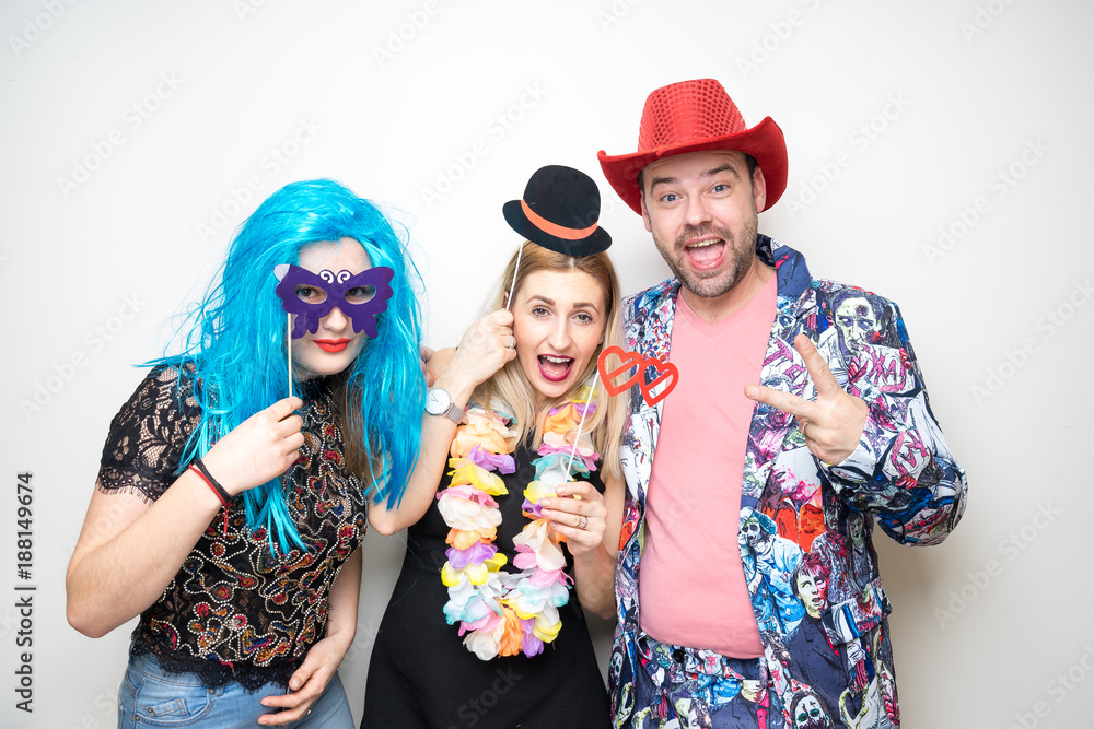 three people funny props pose photo booth happy fun bottle