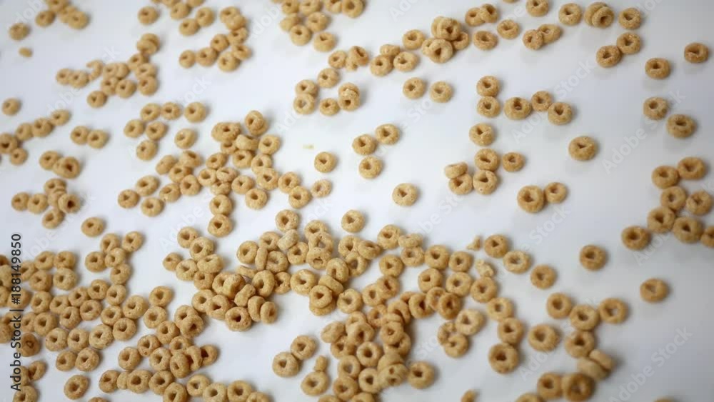Healthy Honey Oat Cereal spinning over white Overhead Angle Healthy Honey Oat Cereal spinning over white Overhead Angle