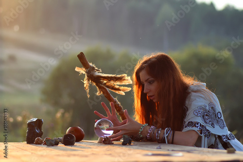 witch with crystal ball at sunset