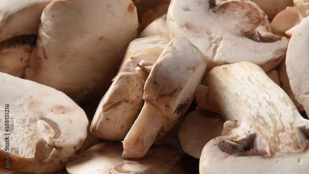 Zoom out shot of sliced mushrooms on a cutting board Zoom out shot of sliced mushrooms on a cutting board