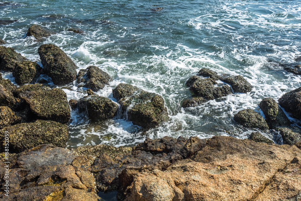 Sea waves splash on stones.