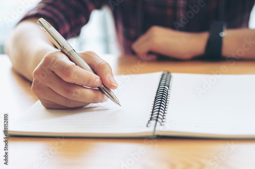 Close-up Of Student hands with pen writing on notebook