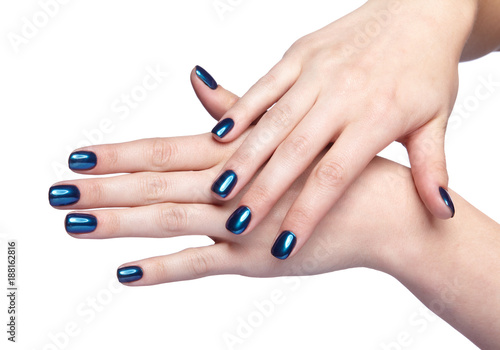 Female hands with blue and shiny nails manicure isolated on white