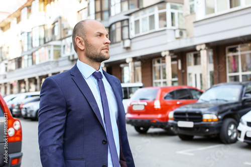 Young man in suit, outdoors © Africa Studio