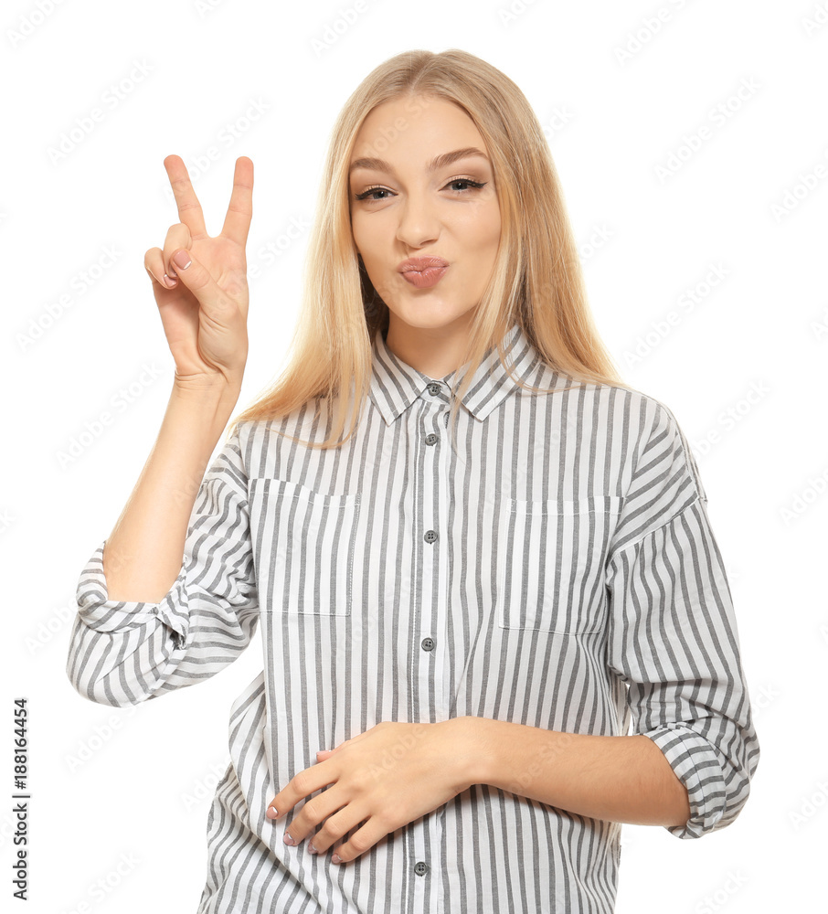 Young funny woman showing victory gesture on white background Young funny woman showing victory gesture on white background