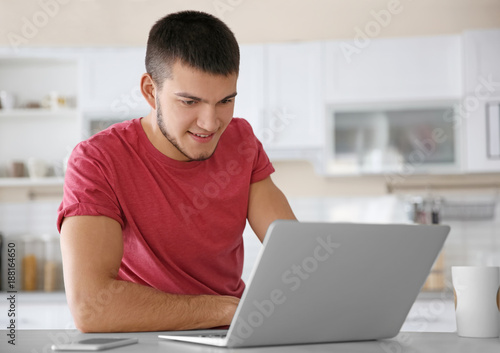 Young man using laptop at home