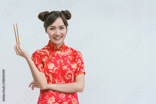 Young Chinese woman holding chopsticks