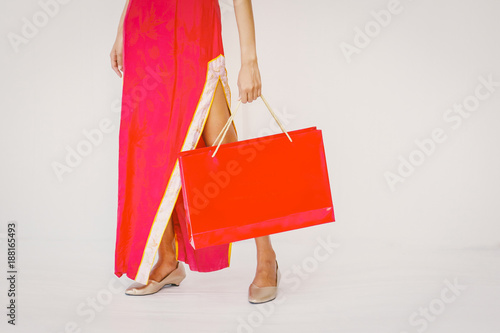 Asian woman holding shopping bag, woman wear cheongsam, chinese new year