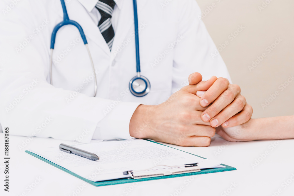 Doctor reassuring her female patient with care on doctors table in hospital.healthcare and medicine Doctor reassuring her female patient with care on doctors table in hospital.healthcare and medicine