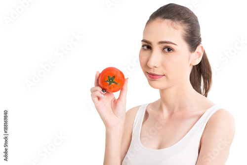 Beautiful woman holding a red tomato isolated on white background