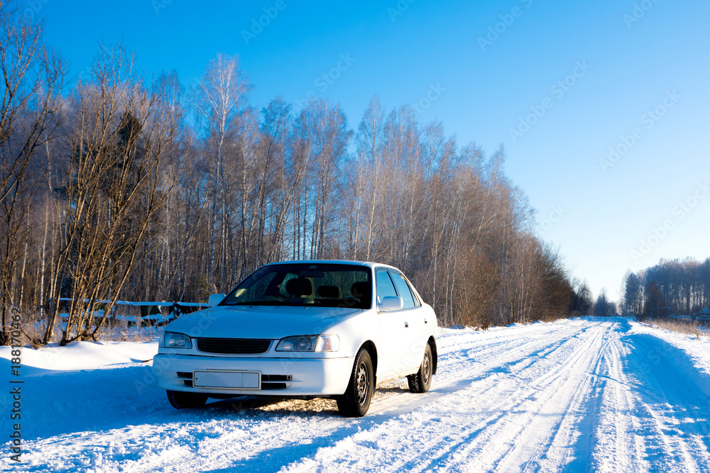 white car on winter snowy country road, front view white car on winter snowy country road, front view