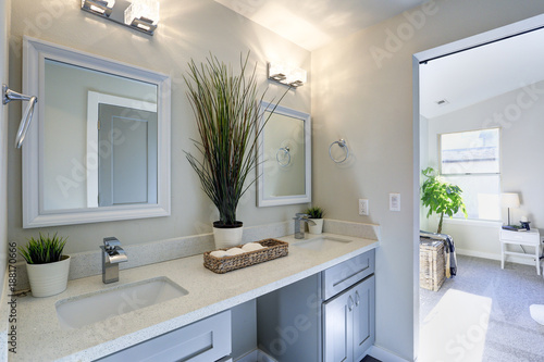Warm and clean bathroom with grey double vanity cabinet