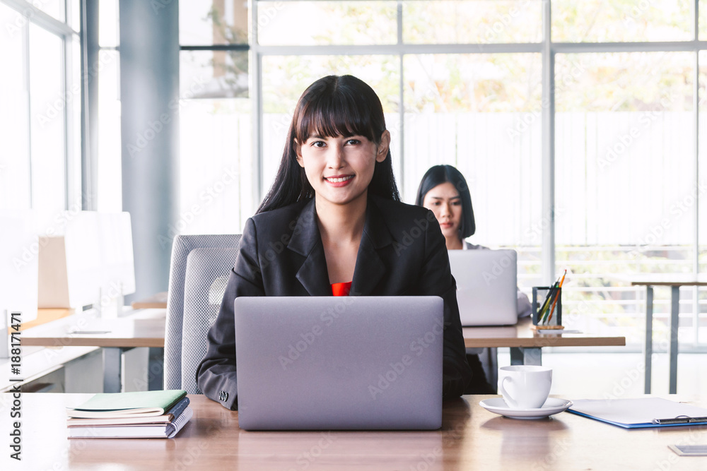 Businesswoman working on notebook computer and business document at office