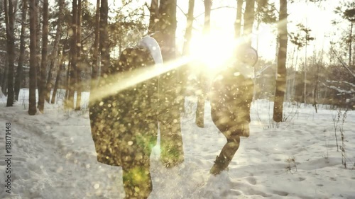 a young couple walk in winter Park, a guy and a girl play in the snow in the Park photo