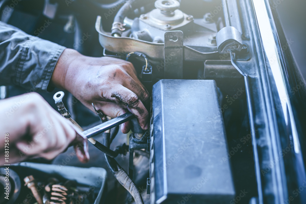 technician working on checking and service car in workshop garage; technician repair and maintenance engine of automobile in car service. technician working on checking and service car in workshop garage; technician repair and maintenance engine of automobile in car service.