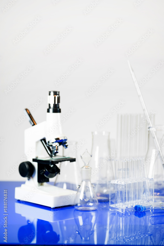 Microscope with lab glassware, science laboratory research concept Microscope with lab glassware, science laboratory research concept