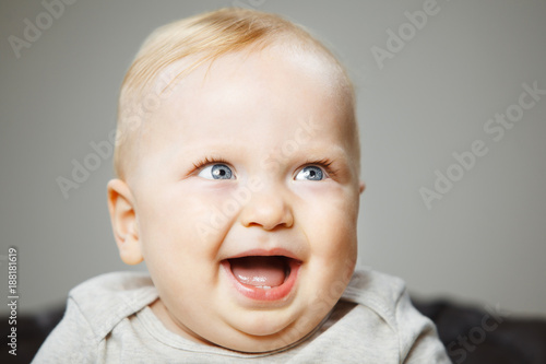 Funny baby with evil genius laugh portrait photo