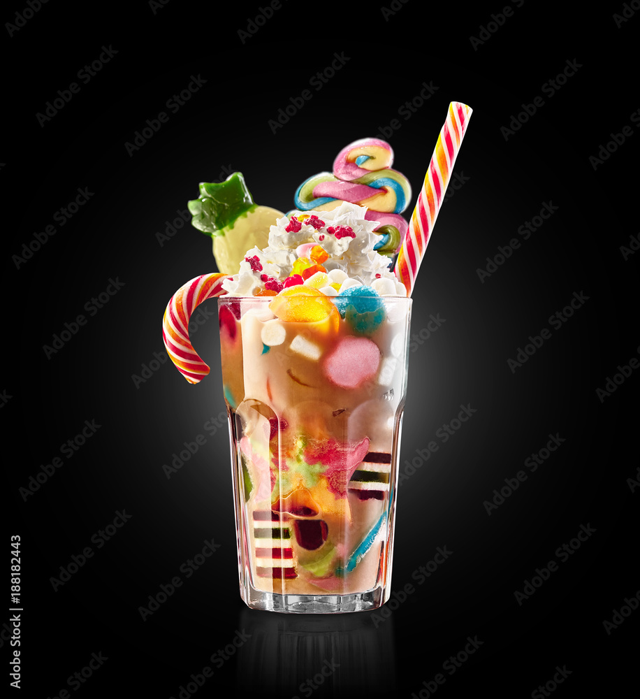 Monster shake, freak caramel shake isolated. Colourful, festive milk shake  cocktail with sweets, jelly. Colored caramel milkshake array of different  childs sweets and treats in glass on black Photos | Adobe Stock