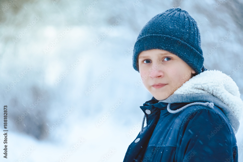 Portrait of a boy in winter knitted Cap. Blizzard. Portrait of a boy in winter knitted Cap. Blizzard.