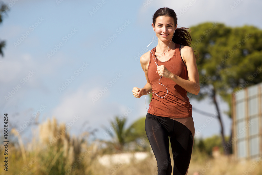 fit young female athlete running outside in morning fit young female athlete running outside in morning