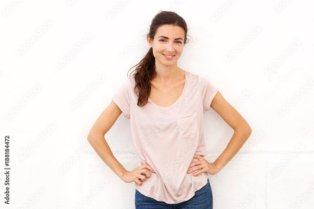 Beautiful woman standing with hands on hips against white background Beautiful woman standing with hands on hips against white background